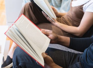 two high-schoolers reading books
