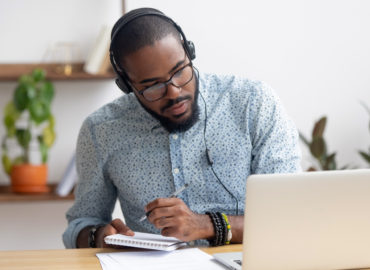 man with headphones working at computer