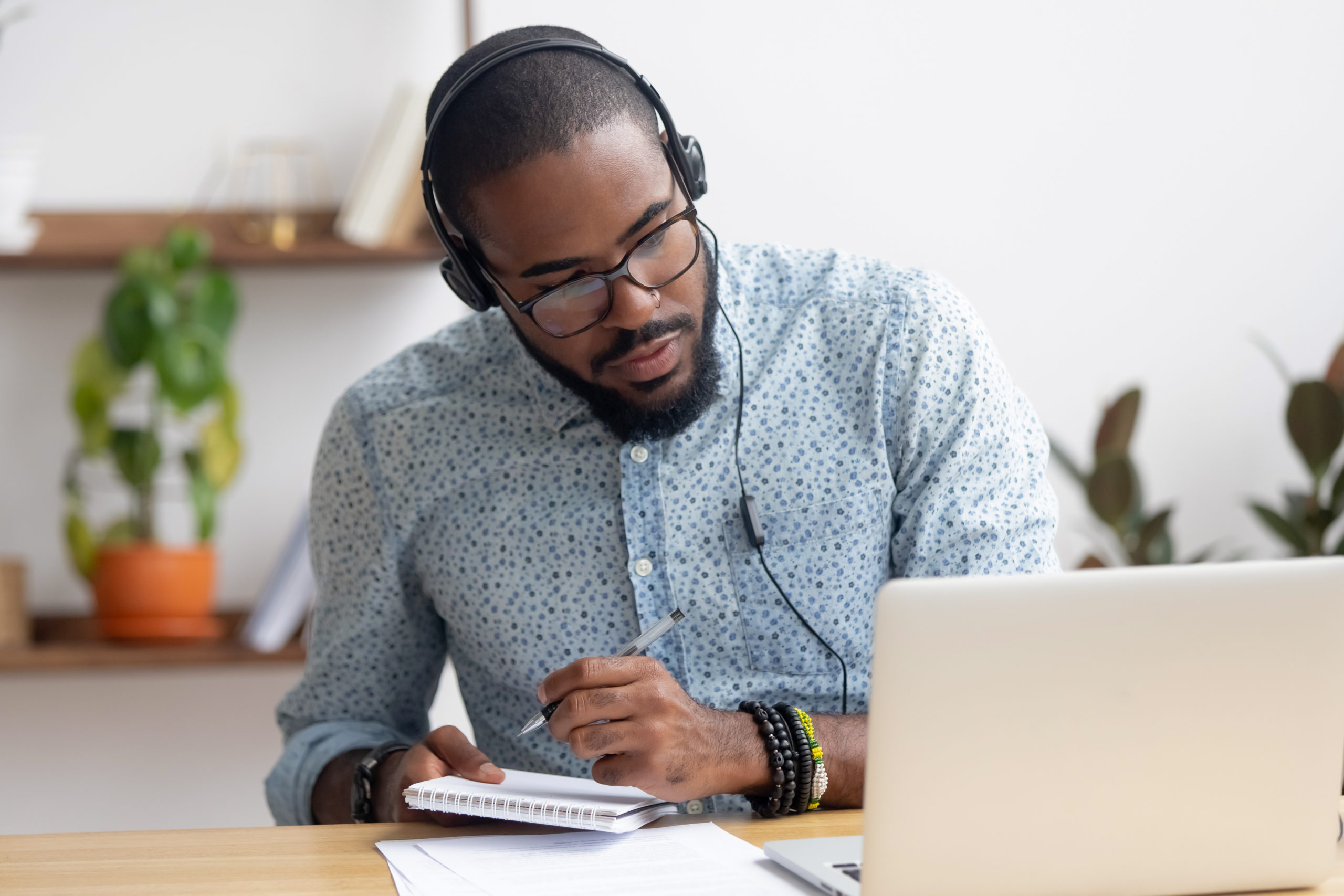 man with headphones working at computer