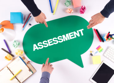fingers pointing to assessment speech bubble