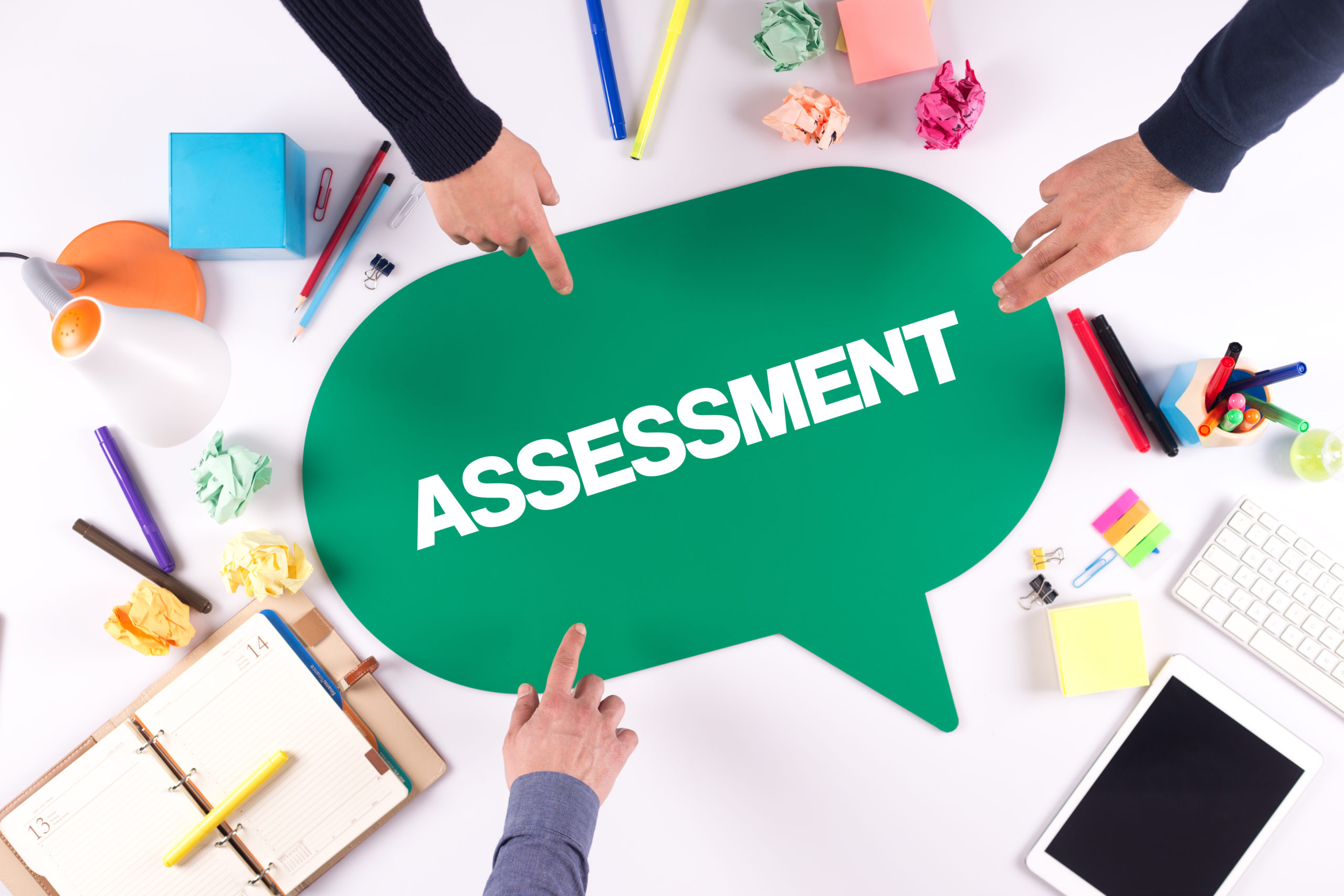 fingers pointing to assessment speech bubble