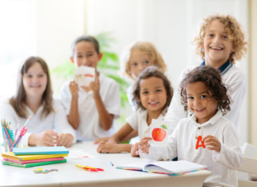 students showing phonics cards