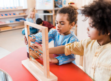 two students using an abacus