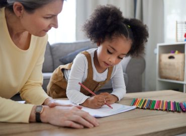 teacher assessing student one-on-one at table