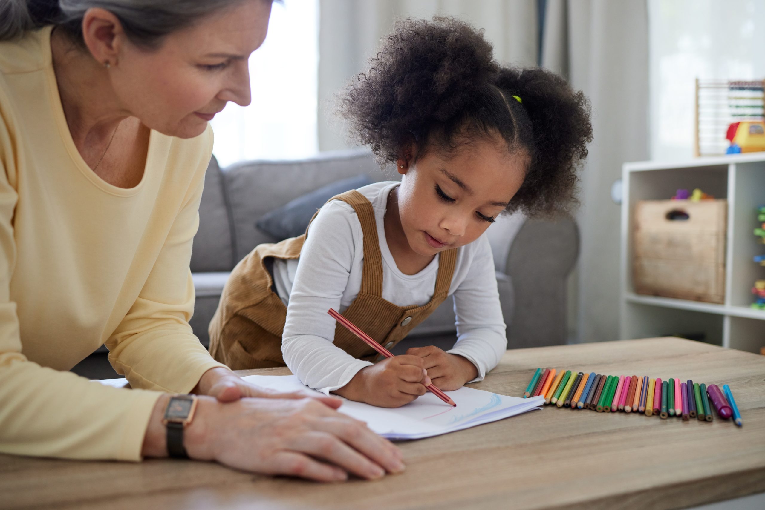 teacher assessing student one-on-one at table