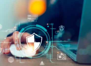 cybersecurity symbols popped out beside laptop